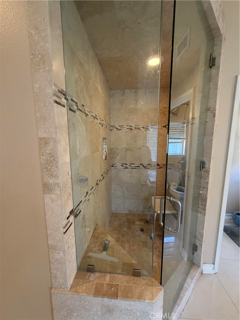 19823 Mariposa Pines Way Porter Ranch, CA 91326 - Photo 31 of 50 a bathroom with a glass shower door