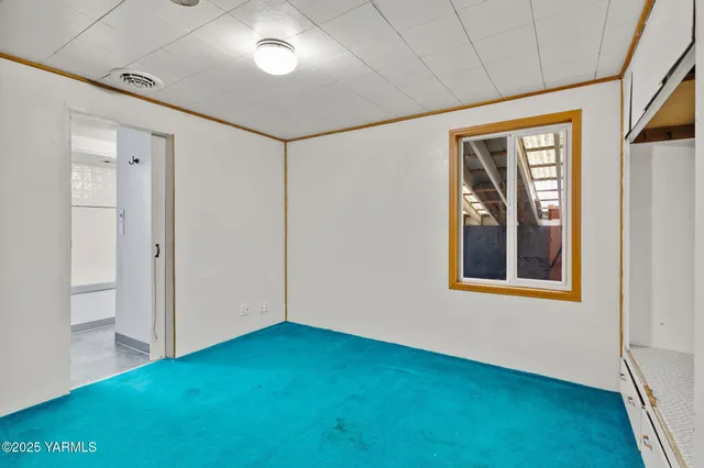 a view of an empty room with a window