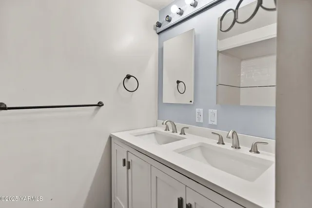 a bathroom with a sink and mirror