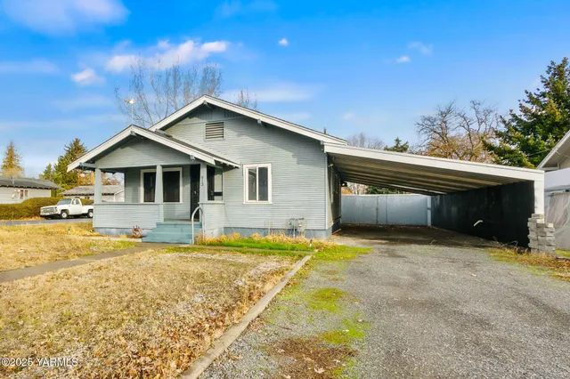 a front view of a house with a yard outdoor seating and garage