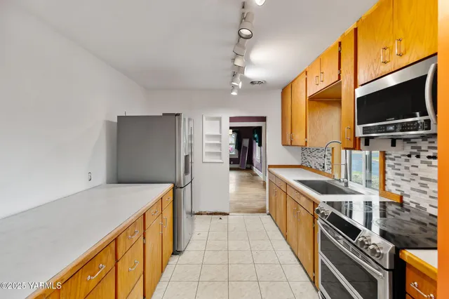 a kitchen with stainless steel appliances a sink and a stove