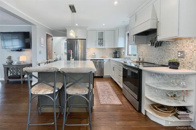 a kitchen with a sink stove and wooden floor