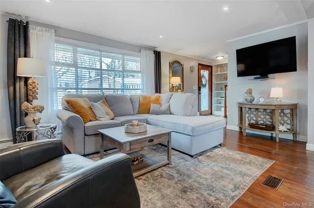 a living room with furniture dining table a fireplace and wooden floor