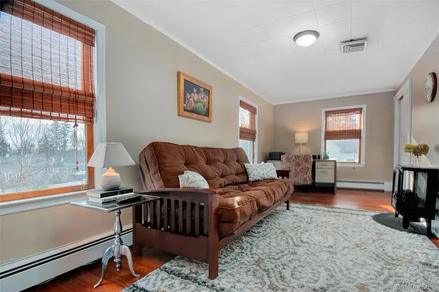 a bedroom with a bed rug and wooden floor