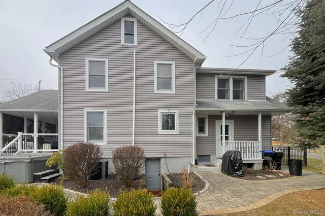 a swimming pool that has lawn chairs with wooden fence