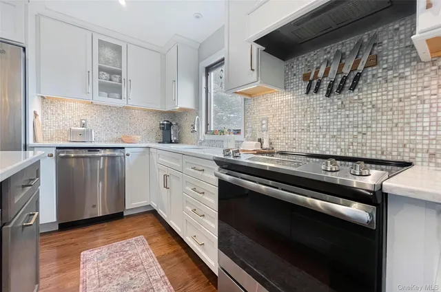 a kitchen with a stove sink and cabinets