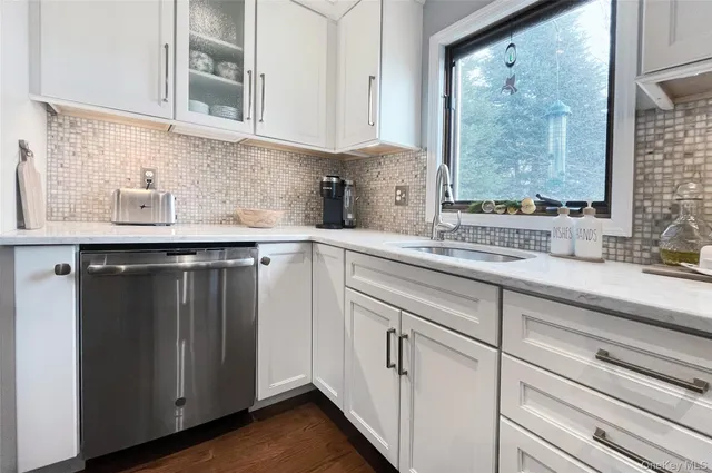 a kitchen with stainless steel appliances white cabinets and a sink