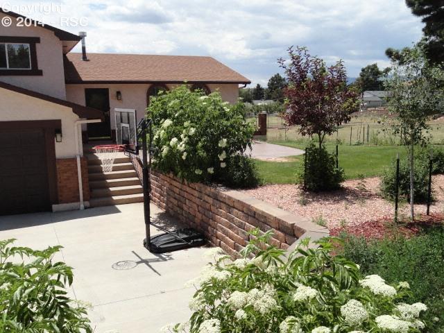 5003 Rocking R Drive Colorado Springs, CO 80915 - Photo 7 of 22 More of the front landscaping and basketball hoop stays!