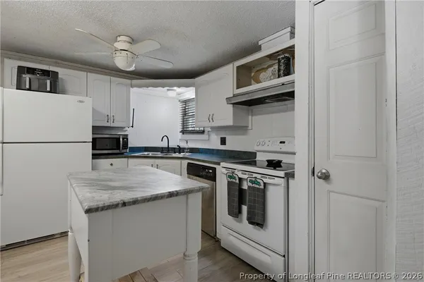 a view of walk in closet with clothes