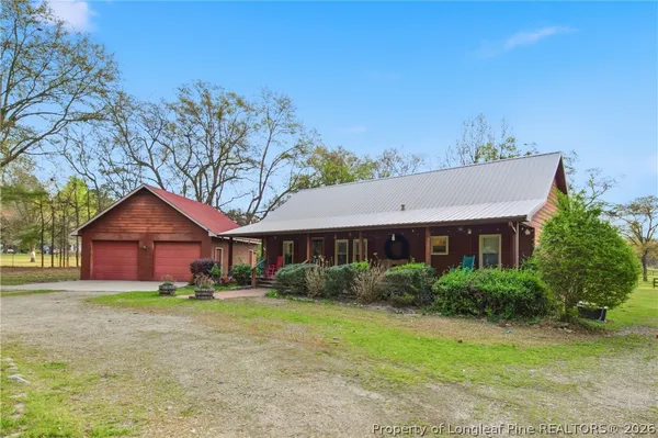 a view of a house with backyard porch and sitting area