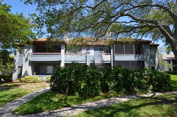 a front view of a house with a yard garage and outdoor seating