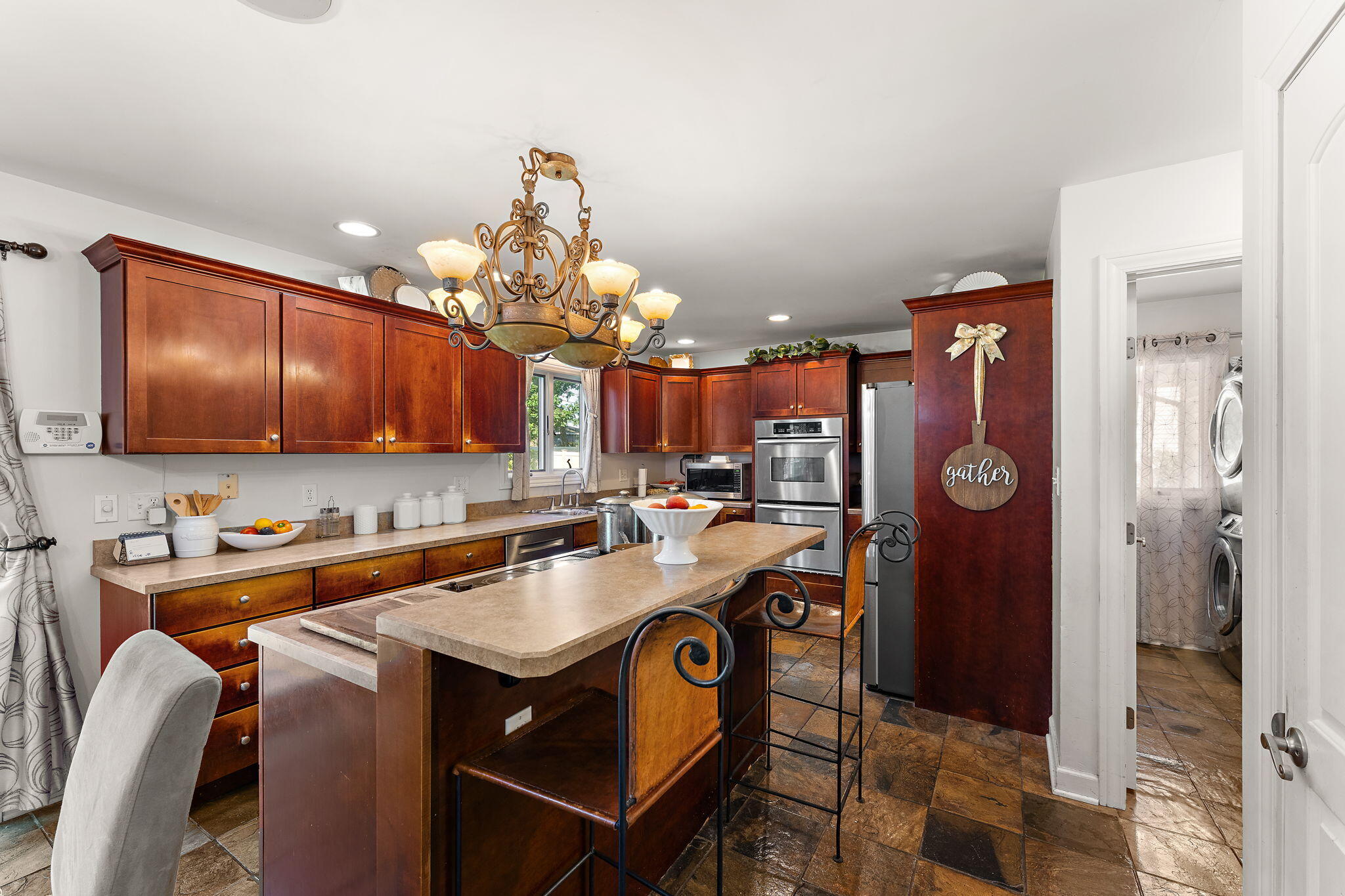 5371 72nd Avenue Schererville, IN 46375 - Photo 8 of 28 a kitchen with stainless steel appliances a sink a microwave cabinets and a dining table