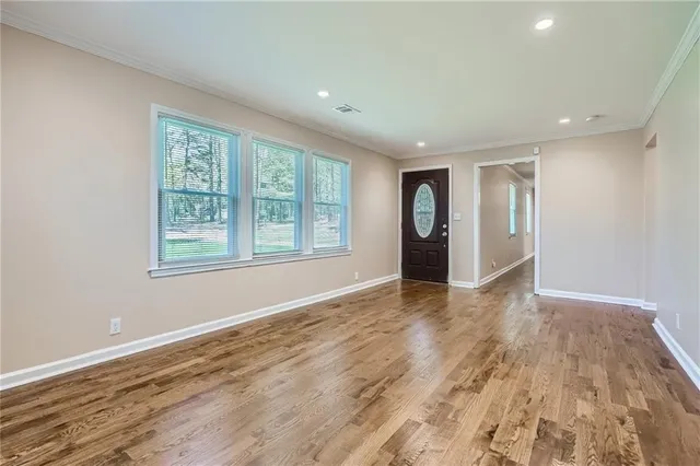 wooden floor in an empty room with a window