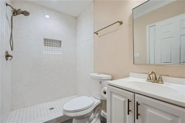 a bathroom with a sink a toilet and a mirror