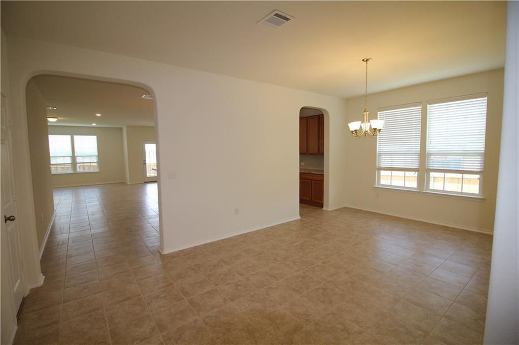 7200 Altidore Drive Austin, TX 78744 - Photo 10 of 23 wooden floor in an empty room with a window