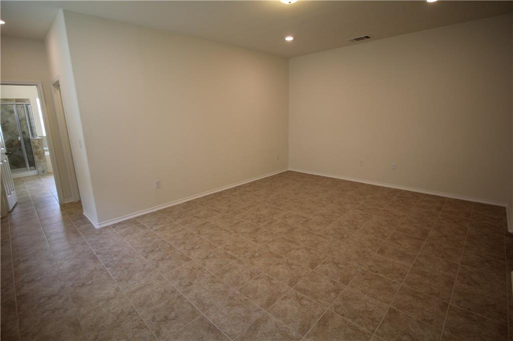 7200 Altidore Drive Austin, TX 78744 - Photo 11 of 23 an empty room with wooden floor and entrance