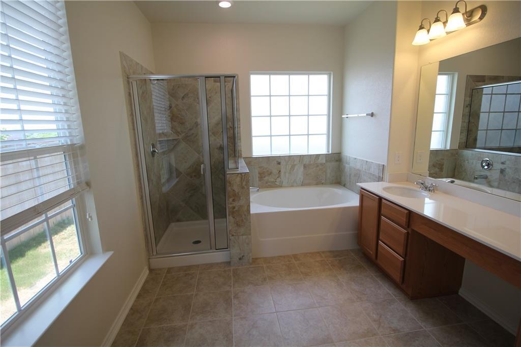 7200 Altidore Drive Austin, TX 78744 - Photo 12 of 23 a spacious bathroom with a tub sink shower and mirror
