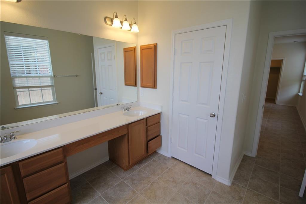 7200 Altidore Drive Austin, TX 78744 - Photo 13 of 23 a spacious bathroom with a double vanity sink and a mirror