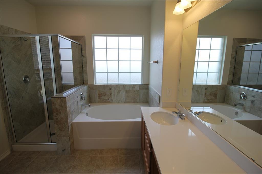 7200 Altidore Drive Austin, TX 78744 - Photo 14 of 23 a bathroom with a tub a sink and a window