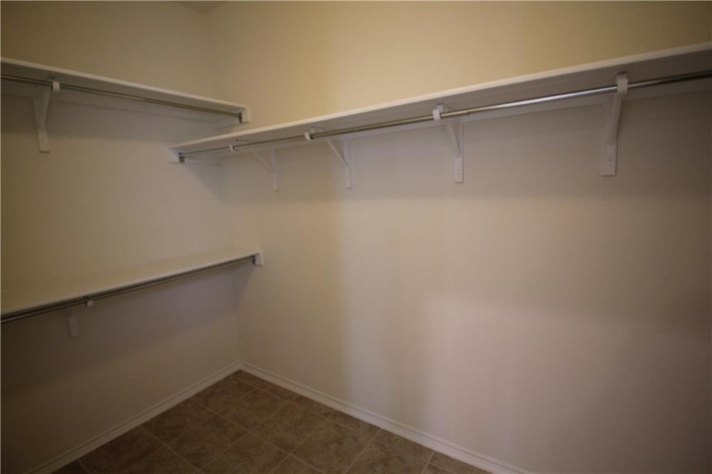 7200 Altidore Drive Austin, TX 78744 - Photo 16 of 23 a view of a room with shelf on the wall