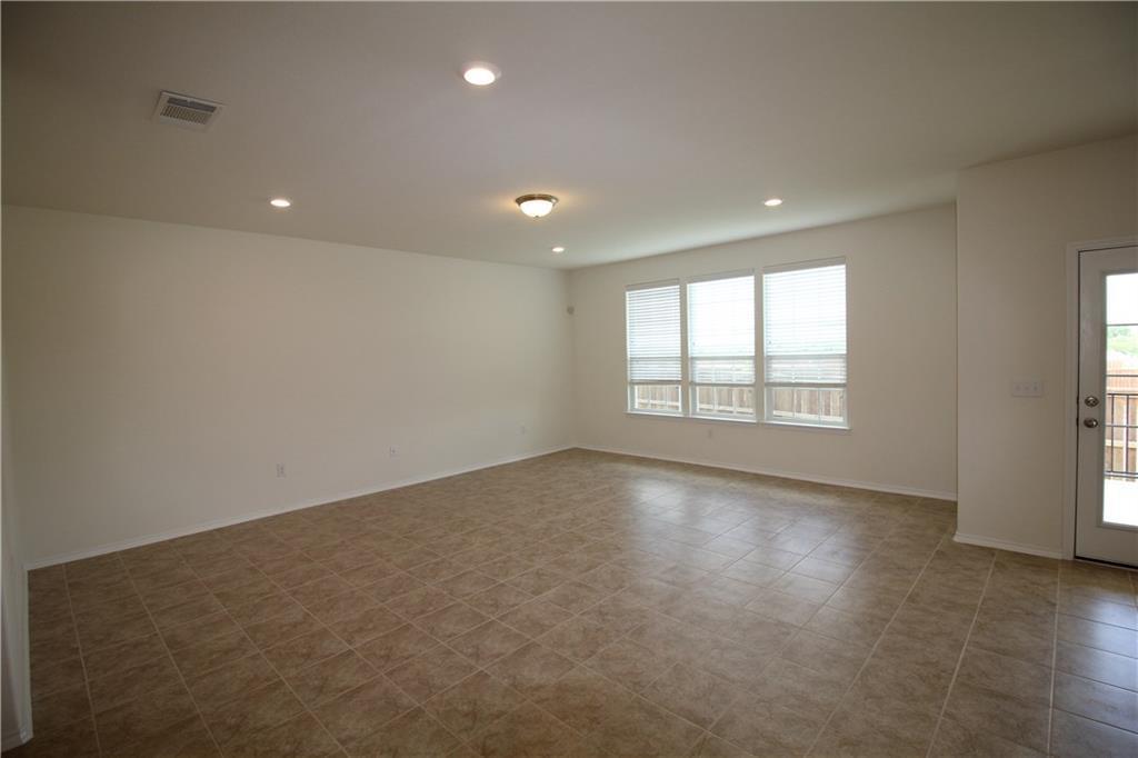 7200 Altidore Drive Austin, TX 78744 - Photo 8 of 23 an empty room with wooden floor and windows