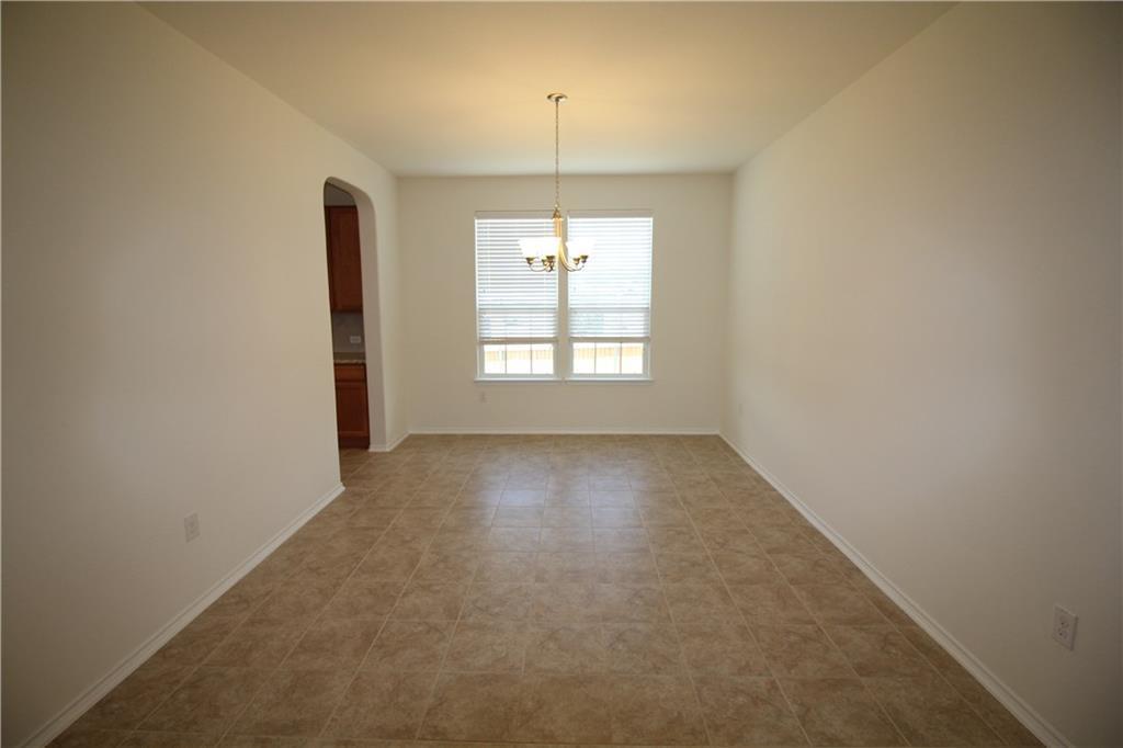 7200 Altidore Drive Austin, TX 78744 - Photo 9 of 23 an empty room with a window and a ceiling fan
