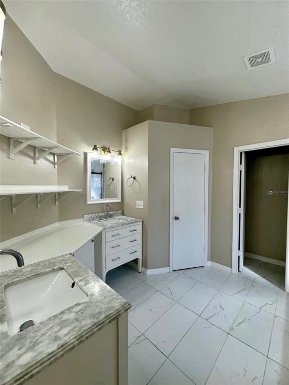 5541 Dark Star Loop Wesley Chapel, FL 33544 - Photo 11 of 14 a bathroom with a granite countertop sink mirror and toilet