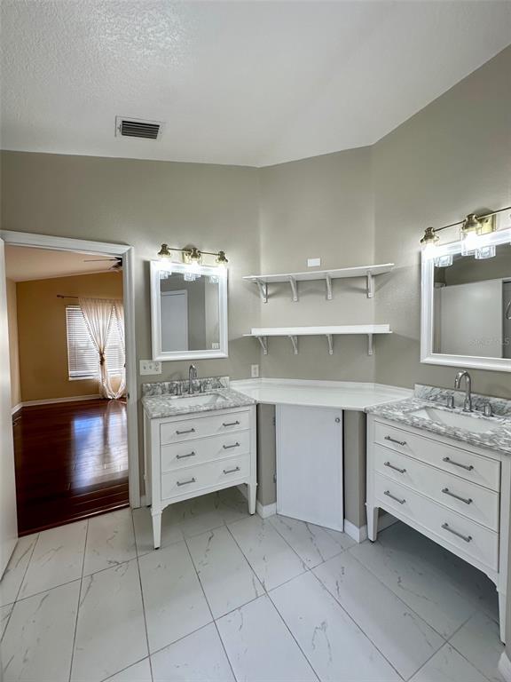 5541 Dark Star Loop Wesley Chapel, FL 33544 - Photo 13 of 14 a room with cabinets and flat screen tv