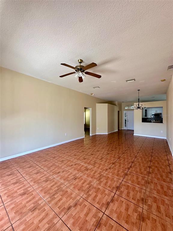 5541 Dark Star Loop Wesley Chapel, FL 33544 - Photo 3 of 14 a view of empty room with kitchen and window