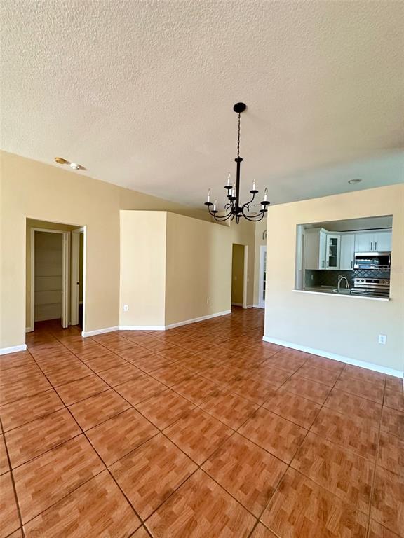 5541 Dark Star Loop Wesley Chapel, FL 33544 - Photo 4 of 14 a view of an empty room with kitchen and window