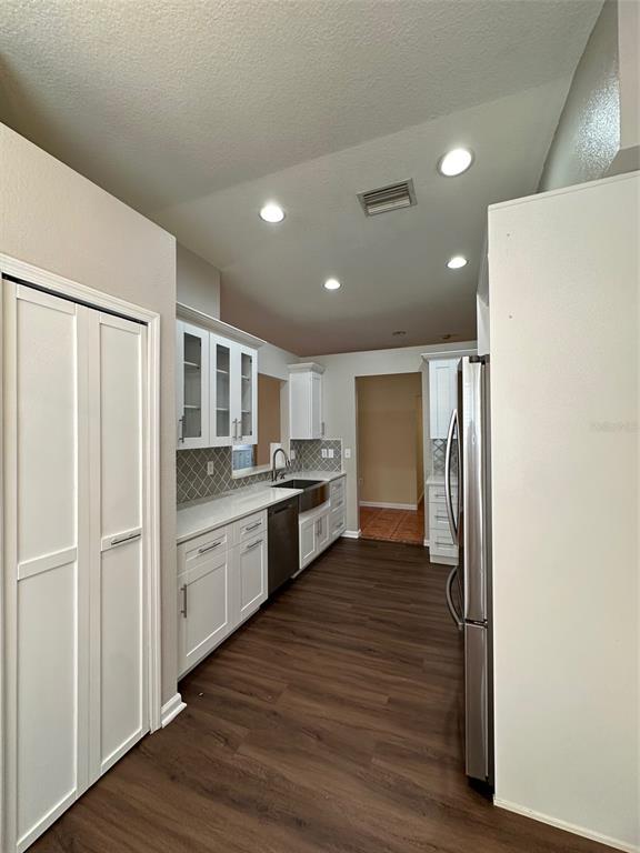 5541 Dark Star Loop Wesley Chapel, FL 33544 - Photo 7 of 14 a large kitchen with a refrigerator and wooden floor