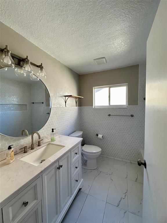 5541 Dark Star Loop Wesley Chapel, FL 33544 - Photo 10 of 14 a bathroom with a double vanity sink mirror and toilet