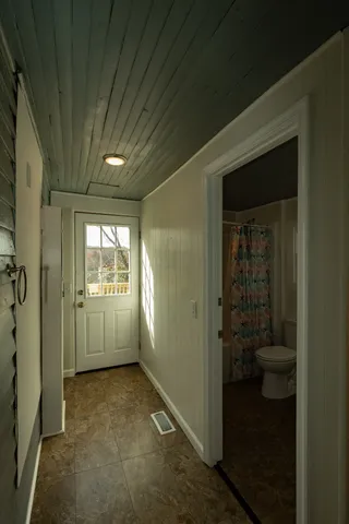 a view of a hallway with a room and a livingroom