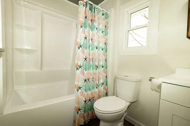 a bathroom with a toilet and a shower