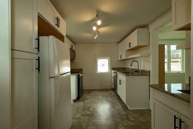 a kitchen with refrigerator and window