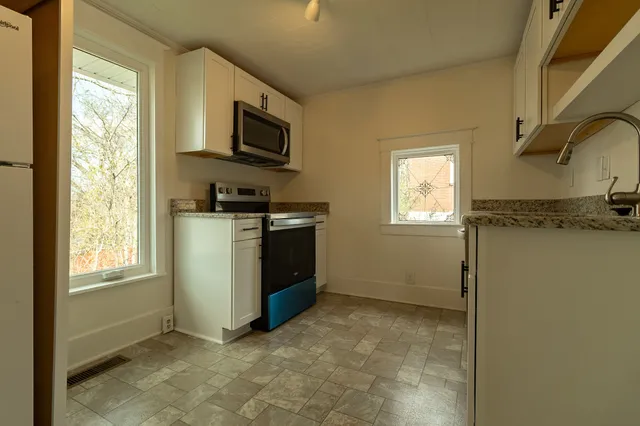 a view of a kitchen with a sink cabinet and a window