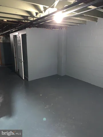 a white toilet sitting next to a bathroom sink and vanity