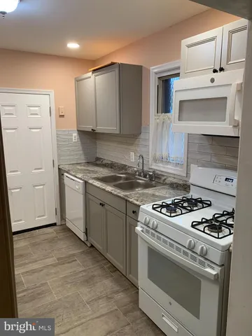a kitchen with cabinets and appliances