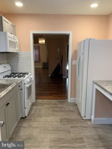 a kitchen with stainless steel appliances a refrigerator and a stove