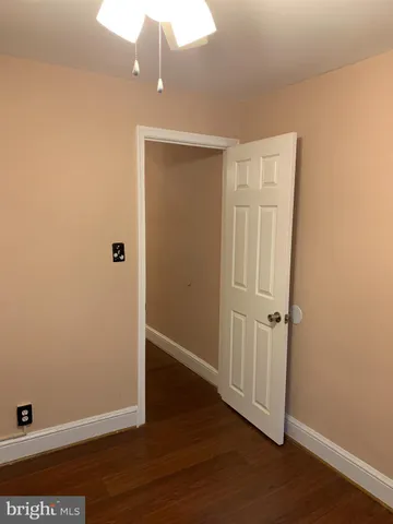 an empty room with wooden floor and closet