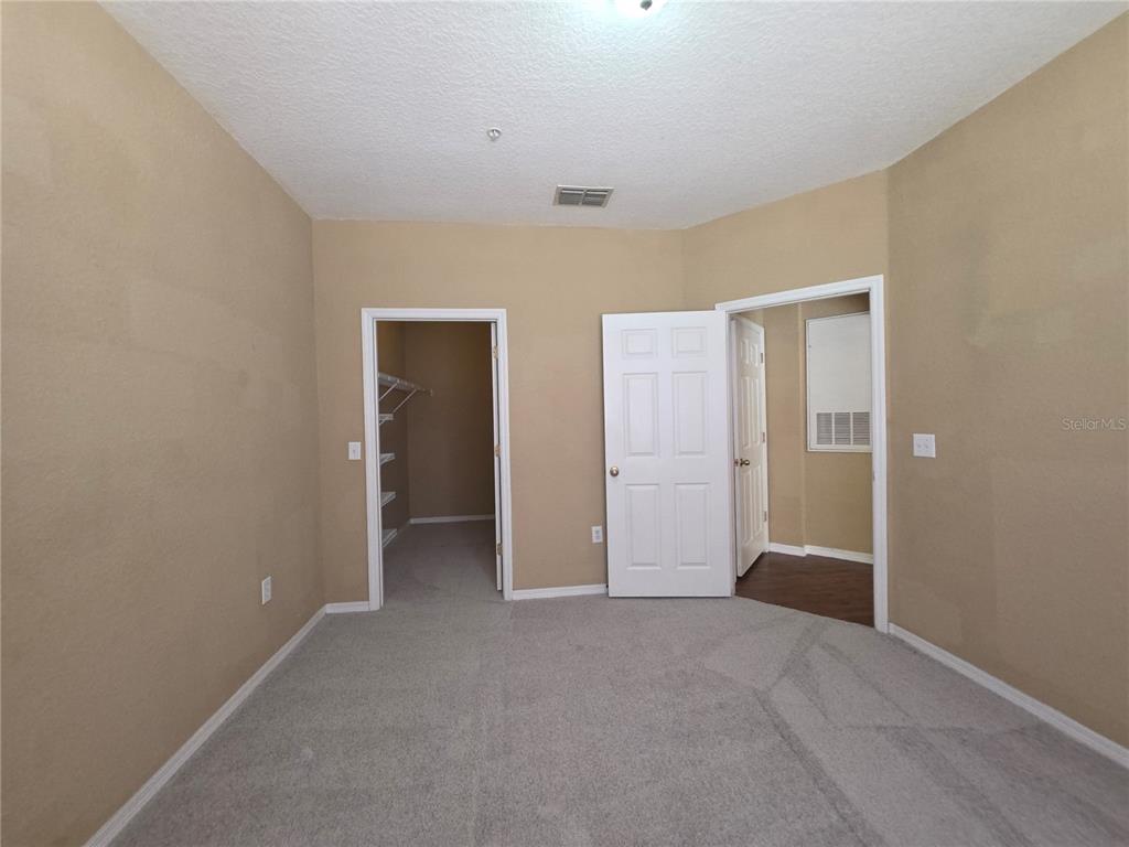 824 Grand Regency Pointe, Unit 101 Altamonte Springs, FL 32714 - Photo 11 of 14 a view of an empty room with closet and a window