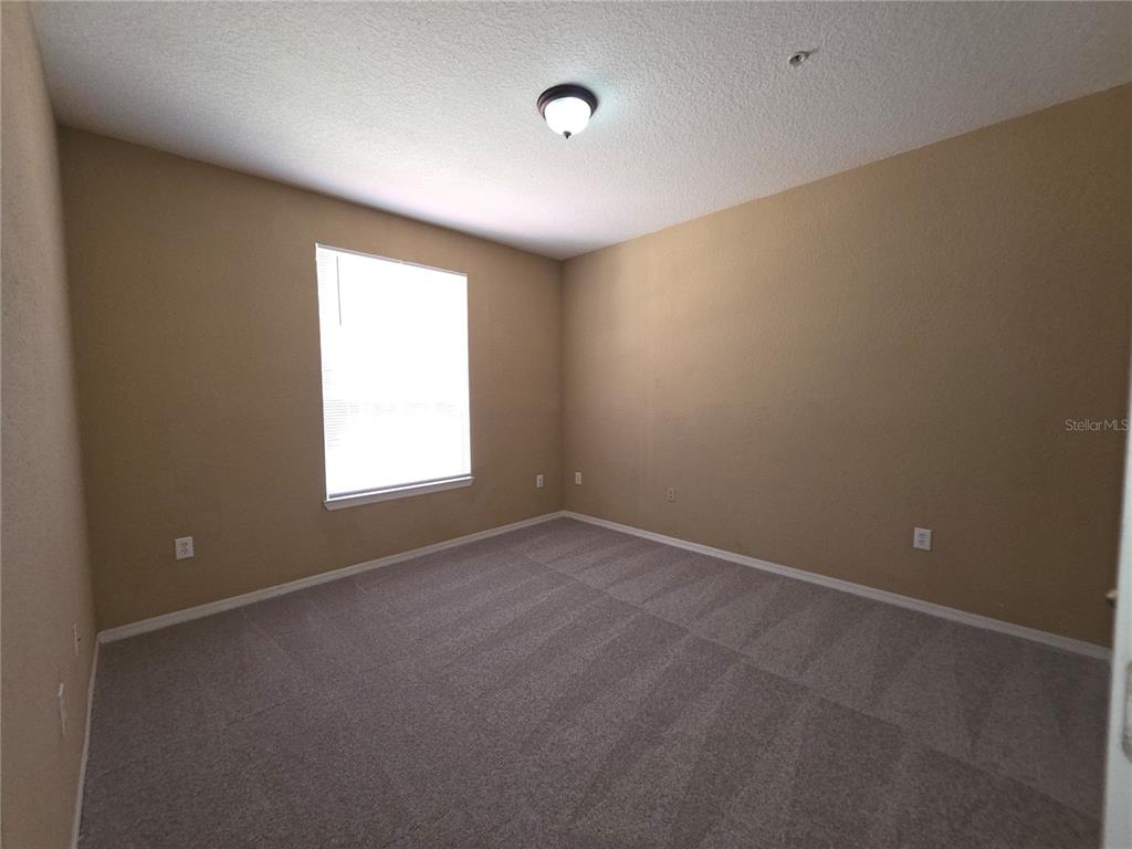 824 Grand Regency Pointe, Unit 101 Altamonte Springs, FL 32714 - Photo 6 of 14 an empty room with a empty space and windows
