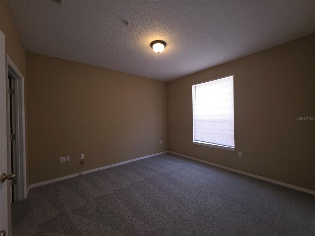 824 Grand Regency Pointe, Unit 101 Altamonte Springs, FL 32714 - Photo 7 of 14 an empty room with a window