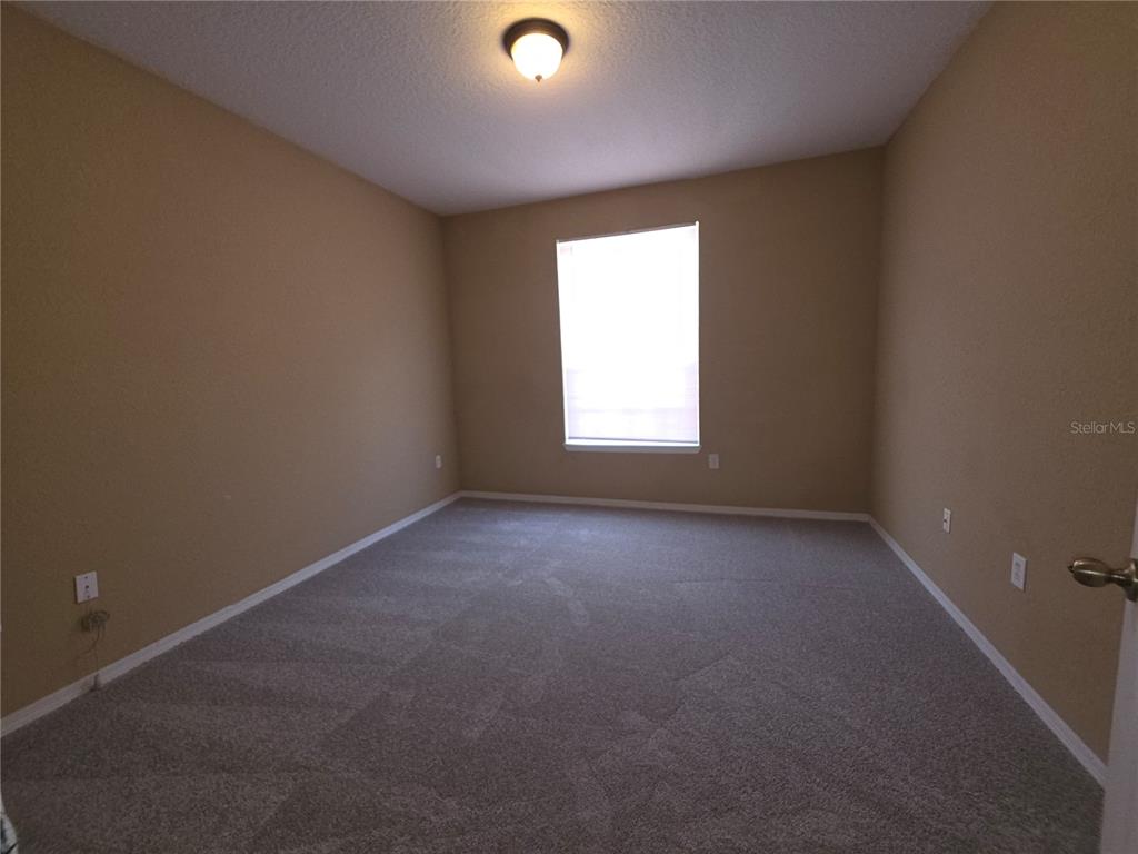 824 Grand Regency Pointe, Unit 101 Altamonte Springs, FL 32714 - Photo 10 of 14 an empty room with a window