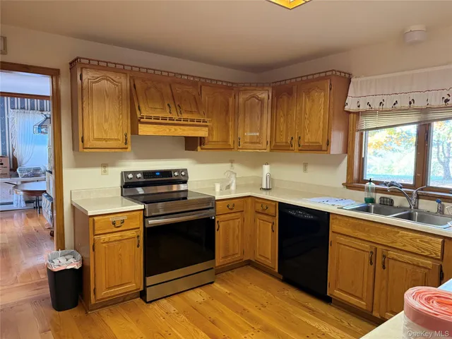 a kitchen with a sink stove and cabinets
