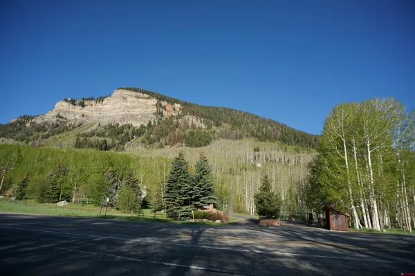 a view of a large building with mountains in the background