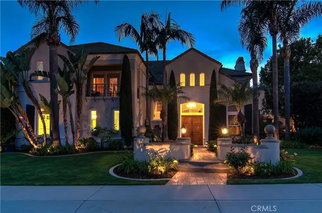 a view of a patio with dining table and chairs under an umbrella with a fire pit