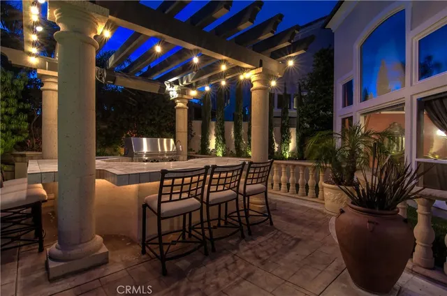 a view of a swimming pool with lawn chairs under an umbrella