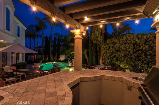 a front view of a house with a yard fountain and fire pit