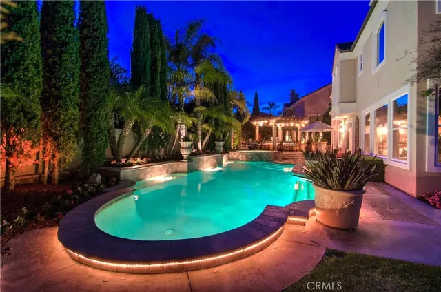 a view of a house with fountain and garden